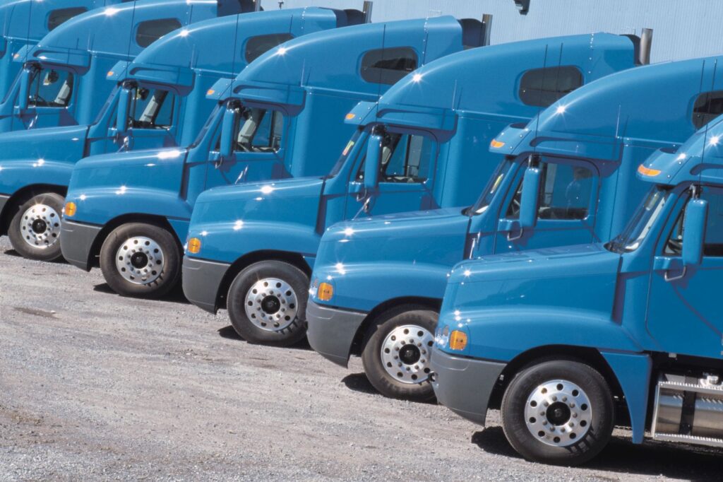 Pelham Truck Accident Lawyer photographs lot of blue commercial trucks  lined up in a row